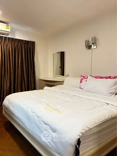 Cozy bedroom with plush bedding and elegant lighting, perfect for relaxation.