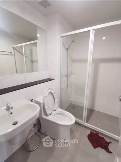 Modern bathroom with sleek shower and contemporary fixtures.