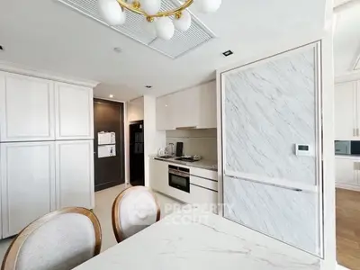 Modern kitchen with sleek white cabinetry and marble accents