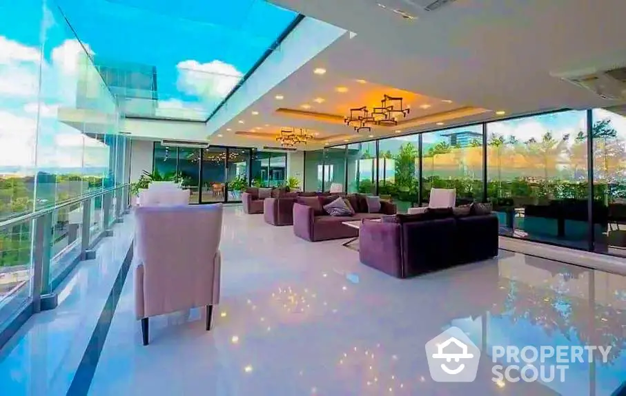 Luxurious modern living room with panoramic glass walls and elegant seating