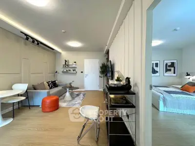 Modern open-plan living room with stylish decor and cozy bedroom view