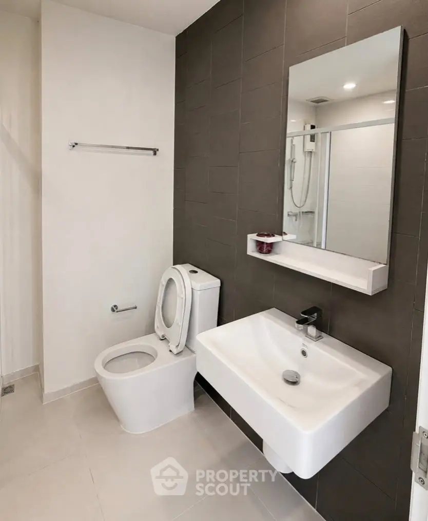 Modern bathroom with sleek fixtures and minimalist design in a contemporary apartment.