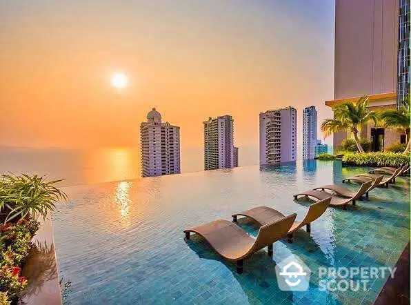 Luxurious rooftop infinity pool with stunning sunset view over city skyline and ocean.