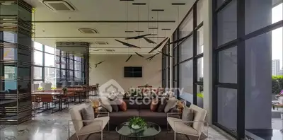 Luxurious modern living room with floor-to-ceiling windows and elegant decor in a high-rise building.