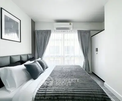 Modern bedroom with stylish decor and natural light in a contemporary apartment.