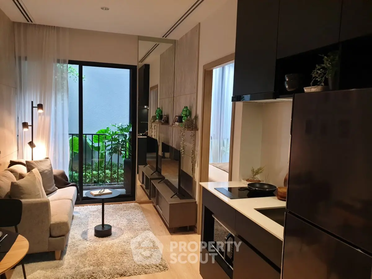 Modern living room with sleek kitchen and cozy balcony view