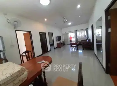 Spacious living room with modern furniture and large windows for natural light.
