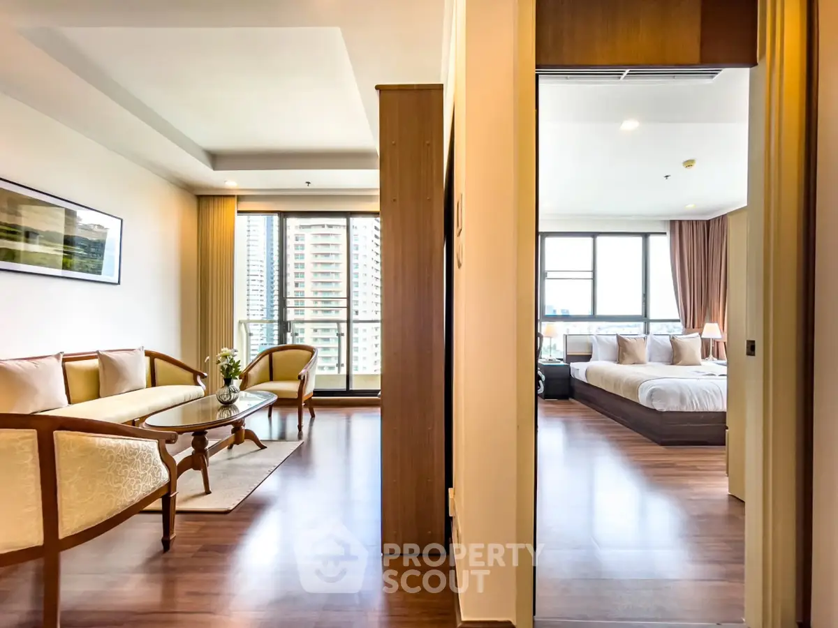 Spacious modern apartment with elegant living room and cozy bedroom, featuring large windows and stylish decor.