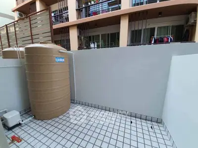 Spacious balcony with water tank in modern apartment building