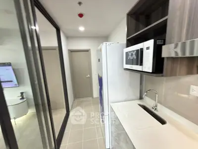 Modern kitchen with sleek appliances and open layout in a contemporary apartment.