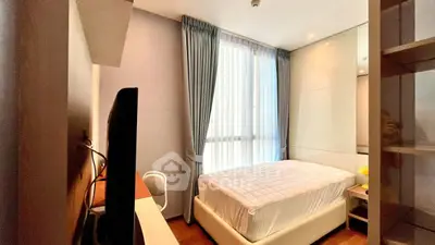 Cozy modern bedroom with natural light and stylish decor.