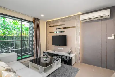 Modern living room with sleek design and balcony view, featuring air conditioning and stylish decor.