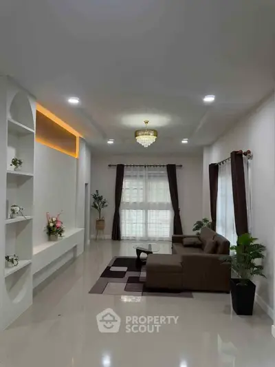 Spacious modern living room with elegant decor and ample natural light.