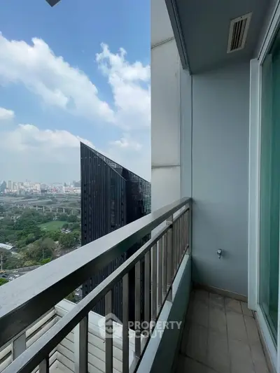 Stunning city view from a modern high-rise balcony with sleek railing.