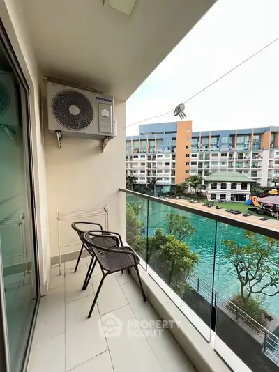 Charming balcony with serene pool view in modern apartment complex