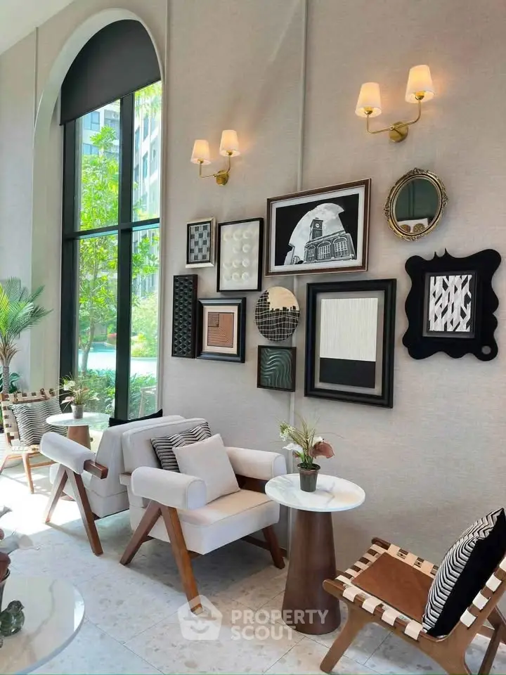 Stylish modern living room with elegant decor and large windows overlooking greenery.