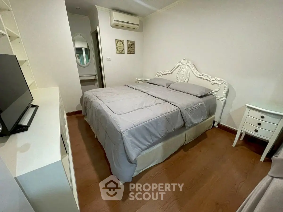 Charming bedroom with elegant bed and modern decor in cozy apartment.