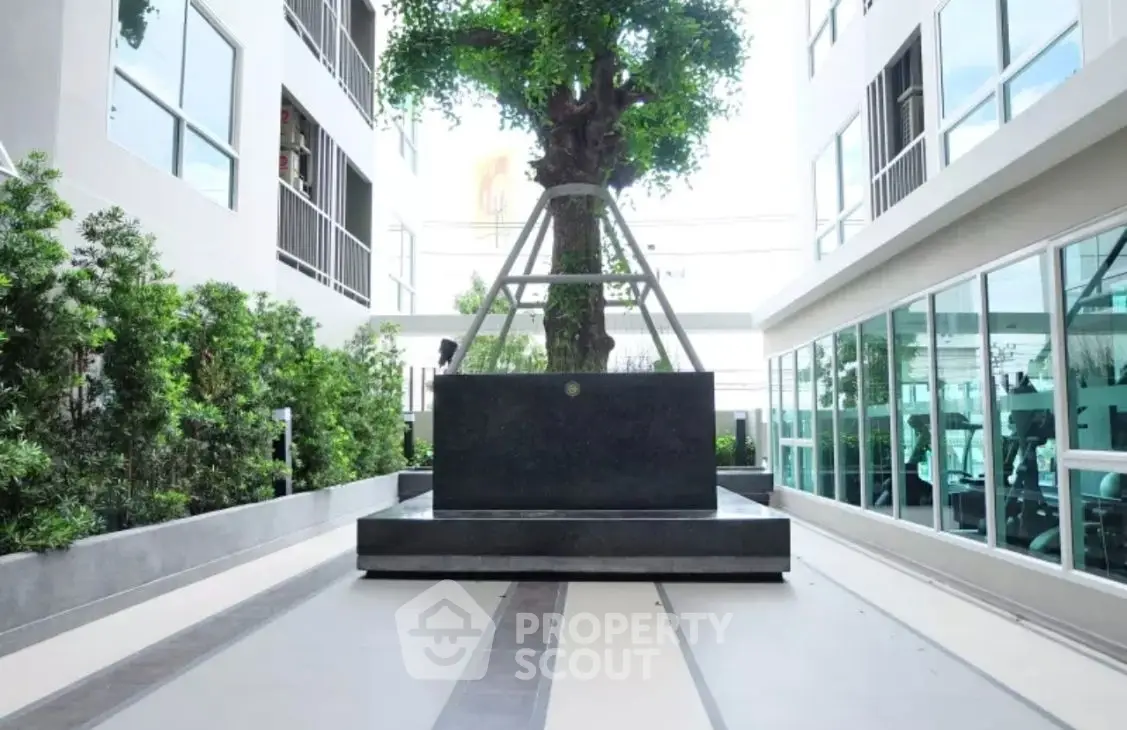 Modern building exterior with sleek design and lush greenery