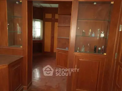 Elegant wooden cabinetry in a spacious home interior with parquet flooring