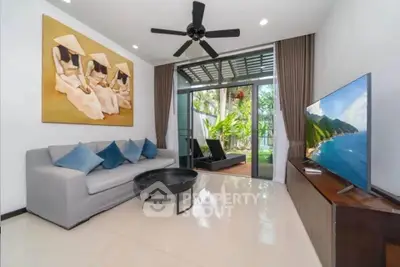 Modern living room with garden view, stylish decor, and sleek furniture.