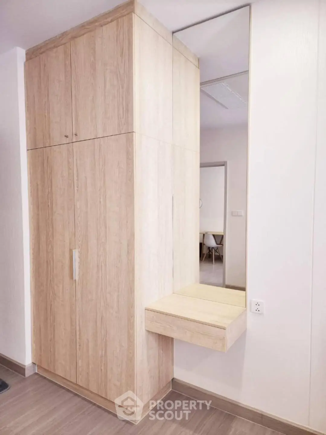 Modern wooden storage unit with mirror in stylish interior design