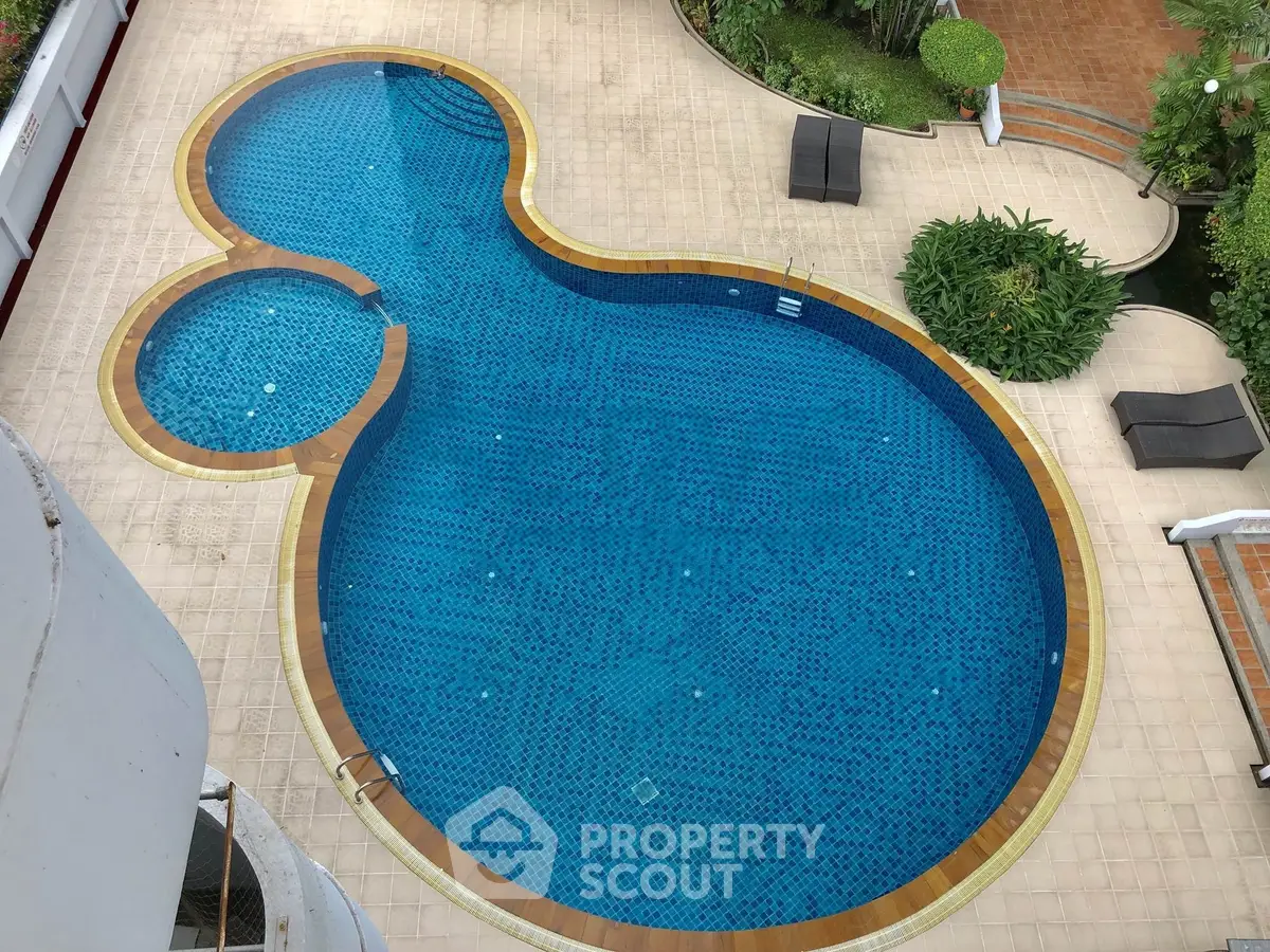 Luxurious outdoor pool area with unique design and lush greenery, perfect for relaxation and leisure.