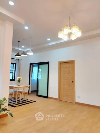 Spacious modern living room with elegant lighting and dining area