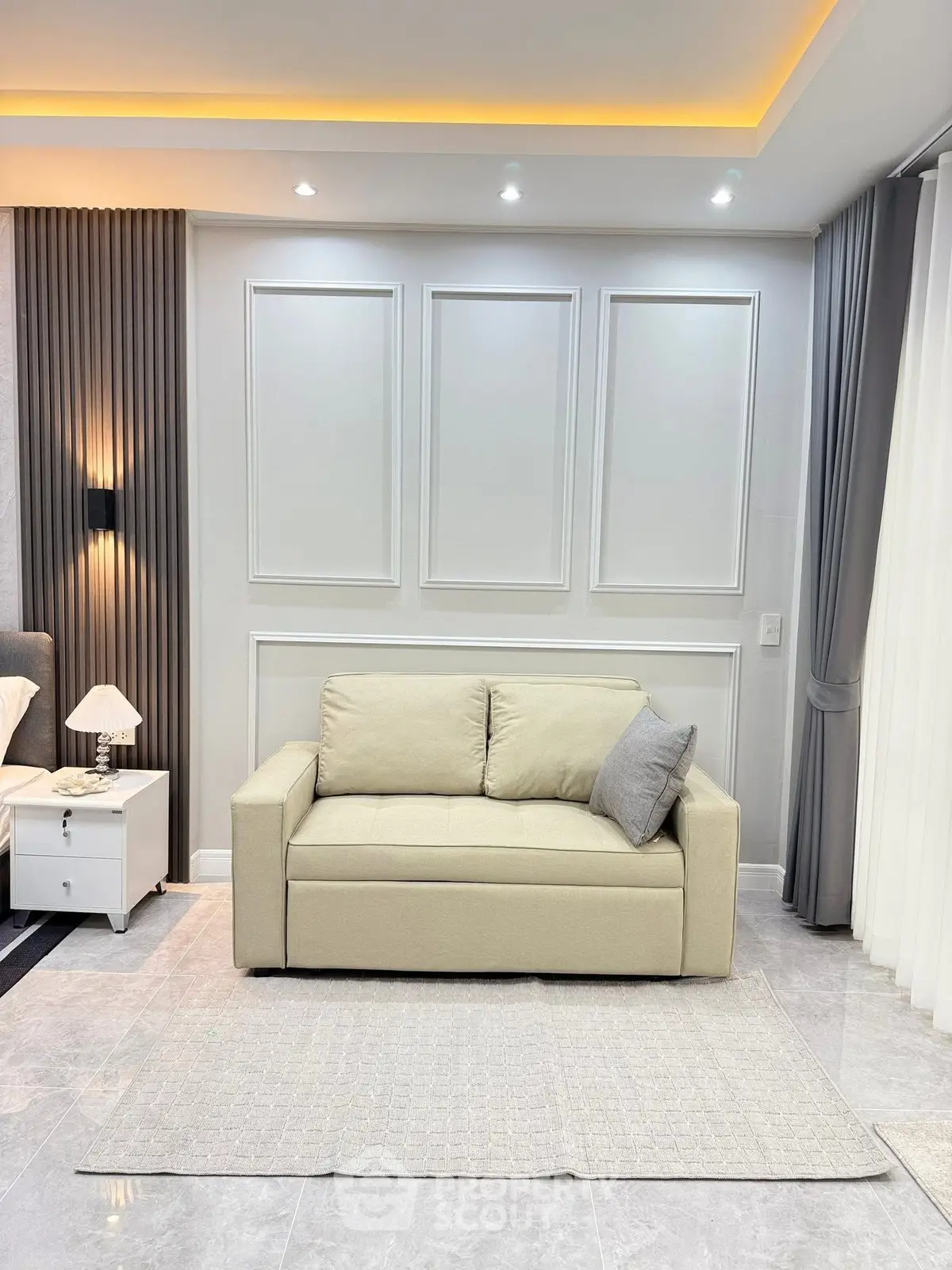 Elegant living room with modern beige sofa and stylish wall paneling