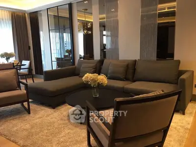 Elegant living room with modern furniture and large windows in luxury apartment.