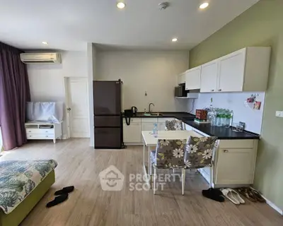 Modern open-layout kitchen with stylish decor and appliances in a cozy apartment.