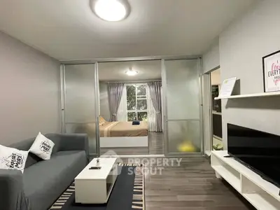 Modern living room with sleek design and cozy bedroom view