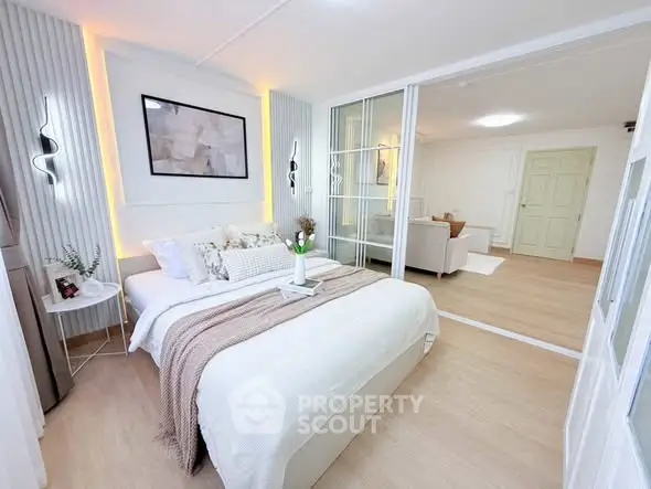 Modern bedroom with stylish decor and cozy ambiance in a contemporary apartment.