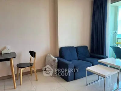 Modern living room with cozy blue sofa and stylish dining area, perfect for urban living.