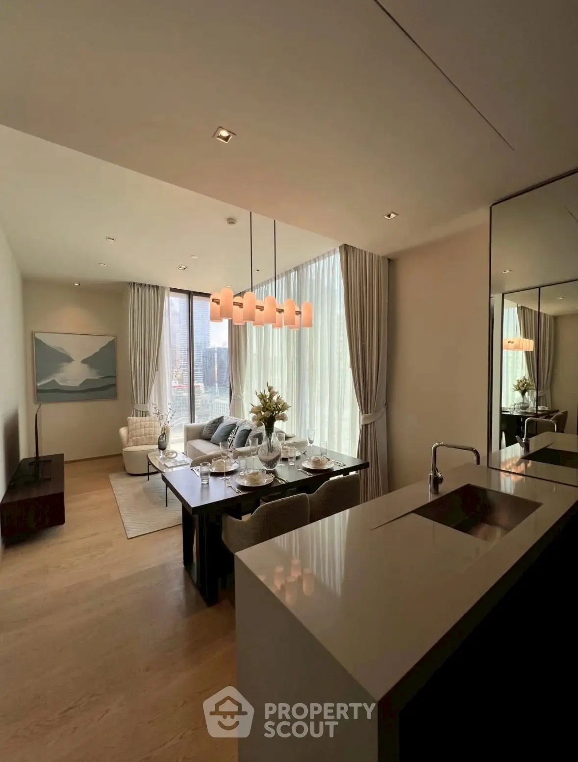 Luxurious open-plan living and dining area with modern decor and city view.