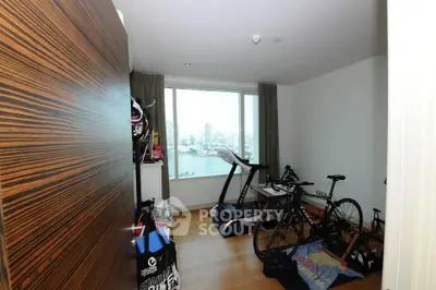 Spacious room with exercise equipment and stunning city view, perfect for fitness enthusiasts.