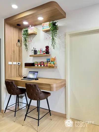 Modern study nook with wooden desk, stylish chairs, and decorative shelves in a cozy home interior.