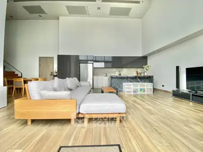 Spacious modern living room with open kitchen and elegant wooden flooring