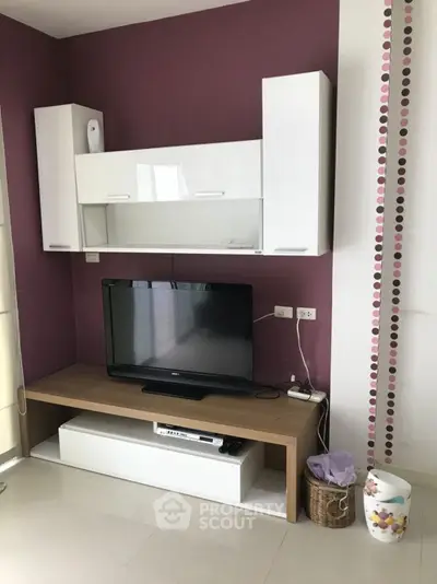 Modern living room with sleek TV unit and stylish wall decor