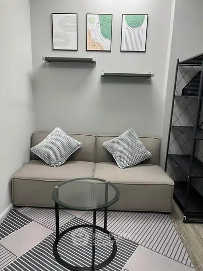 Modern small living room with stylish decor and compact sofa, perfect for cozy urban living.