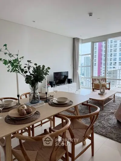 Modern living room with dining area and city view, featuring stylish decor and natural light.