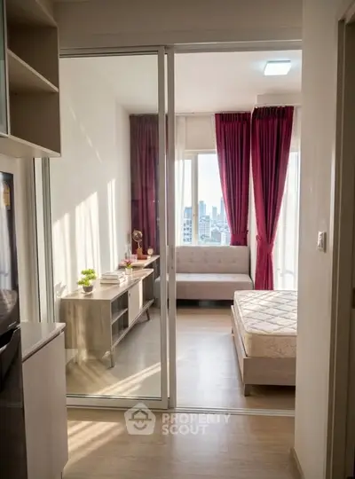 Modern bedroom with city view, featuring floor-to-ceiling windows and elegant decor.