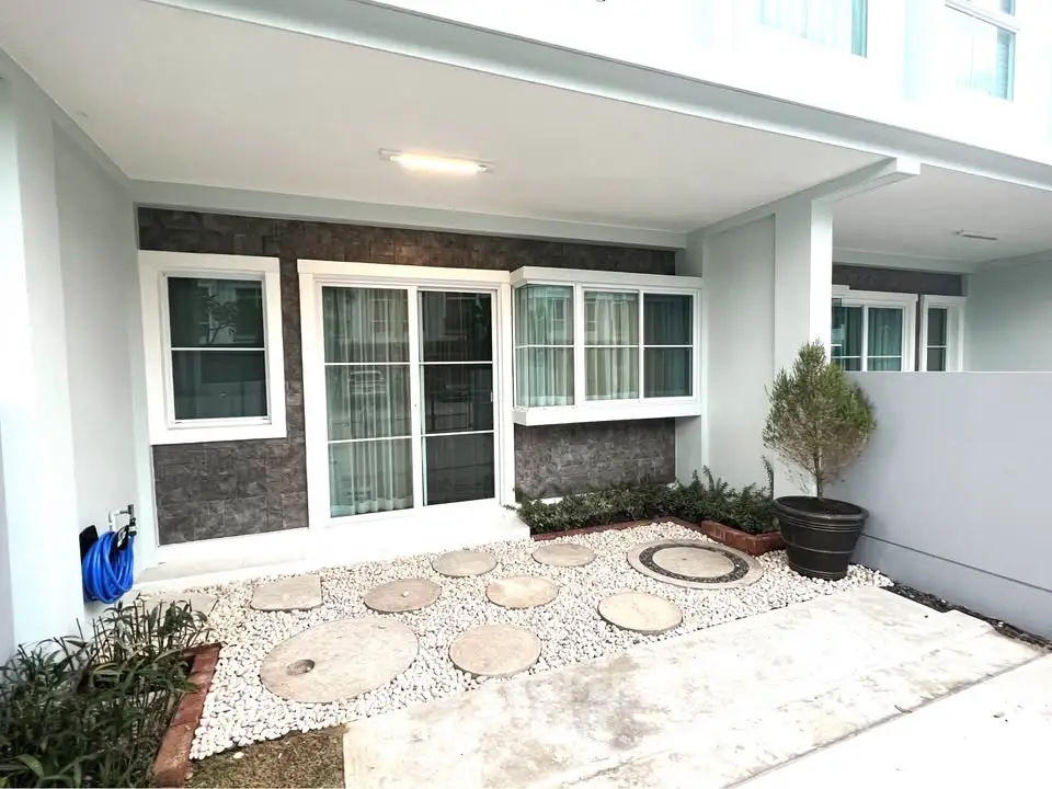 Modern exterior view of a stylish home with stone accents and landscaped garden.