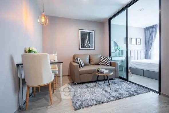 Modern living room with cozy sofa and stylish decor adjacent to a bedroom