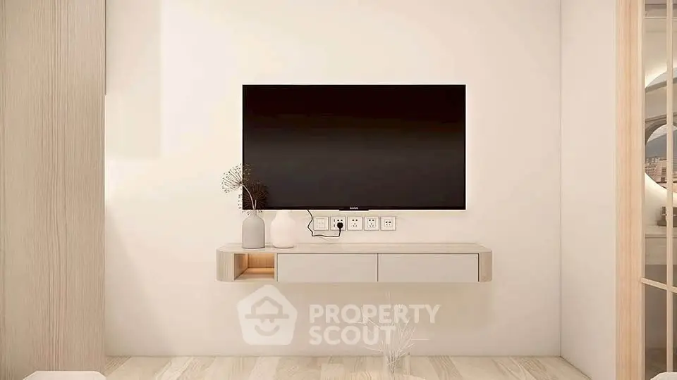 Modern minimalist living room with wall-mounted TV and sleek decor.