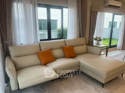Spacious modern living room with elegant sectional sofa and large windows