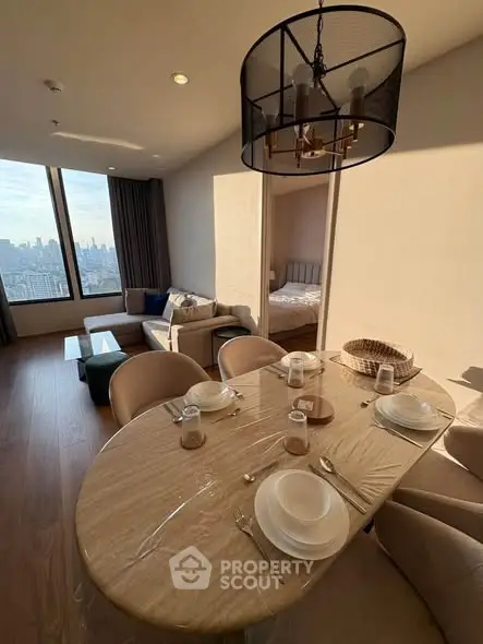 Spacious modern apartment with elegant dining area and cozy living room, featuring large windows with city views.