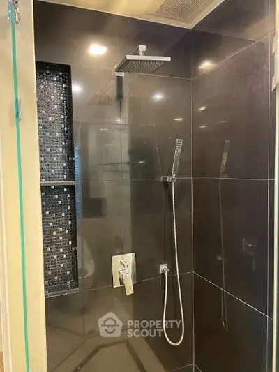 Luxurious modern bathroom with sleek shower design and elegant tile work.