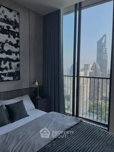 Luxurious bedroom with stunning city view from high-rise balcony.