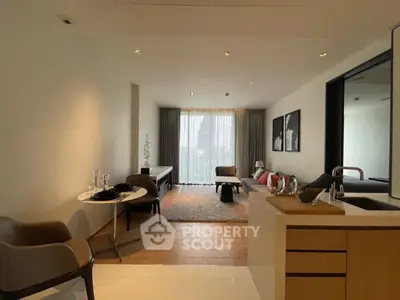 Modern living room with elegant decor and natural light, featuring cozy seating and stylish dining area.