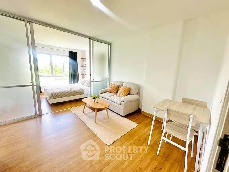 Bright studio apartment with modern furnishings and large window view